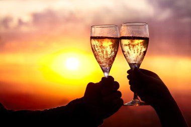 Glasses with champers at sunset clipart