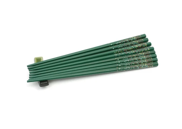 Eight green chopsticks on a support — Stock Photo, Image