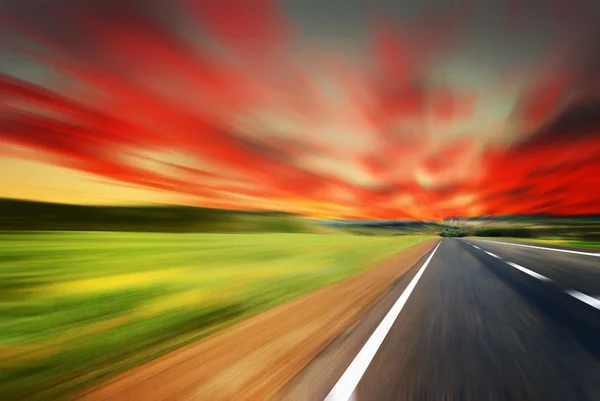 Rozmazané silnice s rozmazané obloha a slunce — Stock fotografie