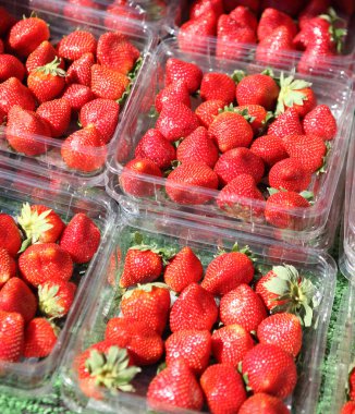 Lot of strawberries on the market clipart