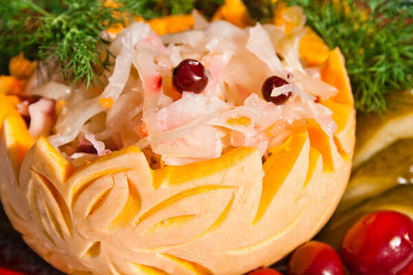Sauerkraut with cowberry in art pumpkin