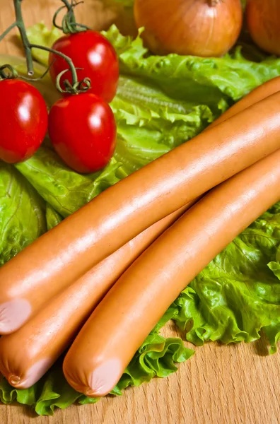 Sausage on green lettuce — Stock Photo, Image