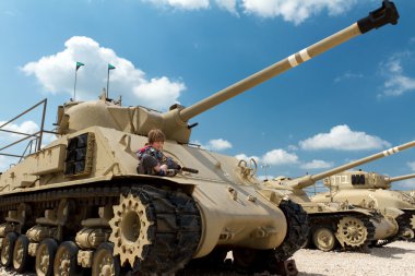 Boy on the tank. clipart
