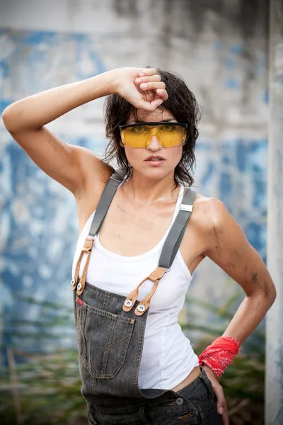 Sexy woman in denim coveralls — Stock Photo, Image