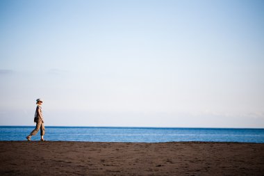 Walking along the beach clipart