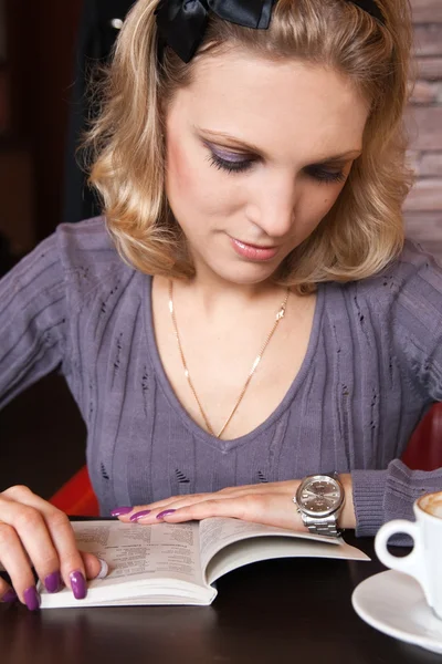Młoda blondynka w kawiarni czytanie książki — Zdjęcie stockowe