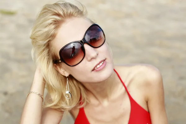 stock image Portrait of a young beautiful girl with glasses on the beach