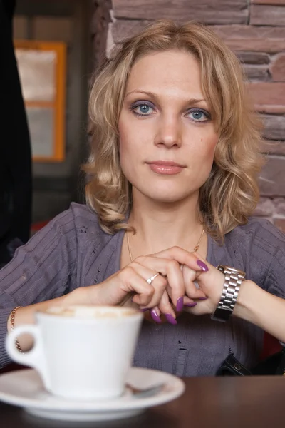 Bir fincan kahve ile bir kafede güzel bir genç kız portresi — Stok fotoğraf