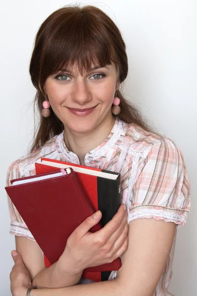 Porträtt av en ung söt student med läroböcker i hand — Stockfoto