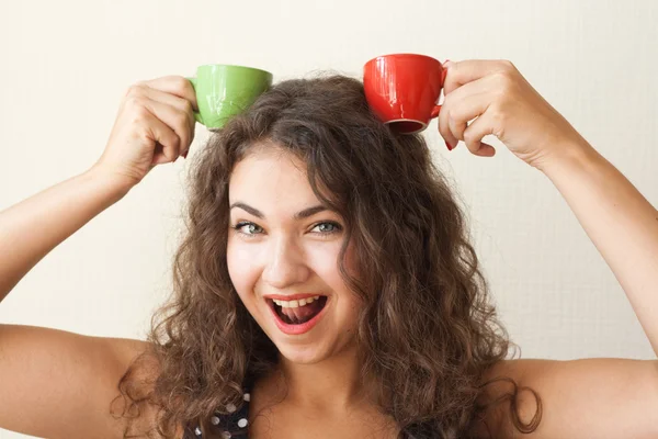 Young beautiful brunette holding two cups — Stock Photo, Image