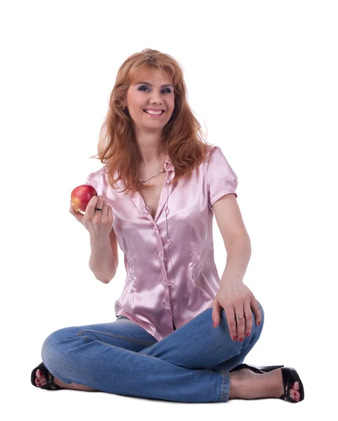 Senior woman in jeans sit with apple — Stock Photo, Image