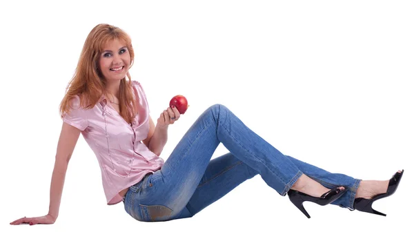 Tall mature woman in jeans sit with apple — Stock Photo, Image