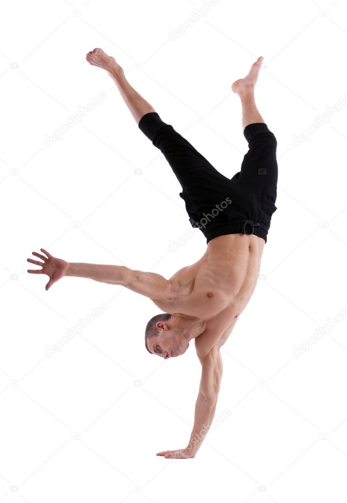 Athletic man posing nude stand on hand