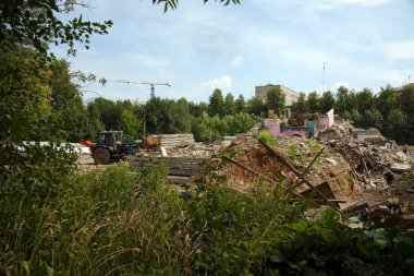 Tractor clean construction site from garbage clipart