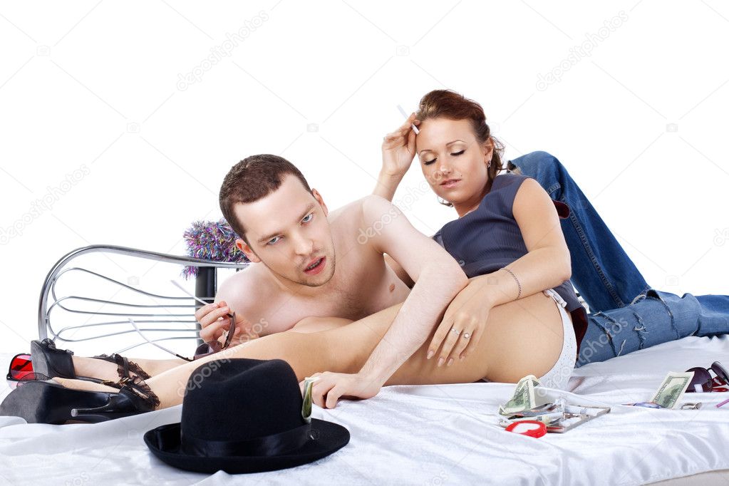 Adult man and woman on bed at morning after party