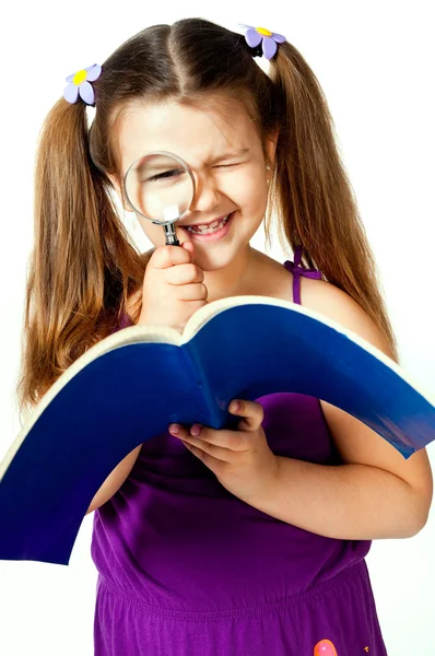 Little girl with a magnifying glass — Stock Photo, Image
