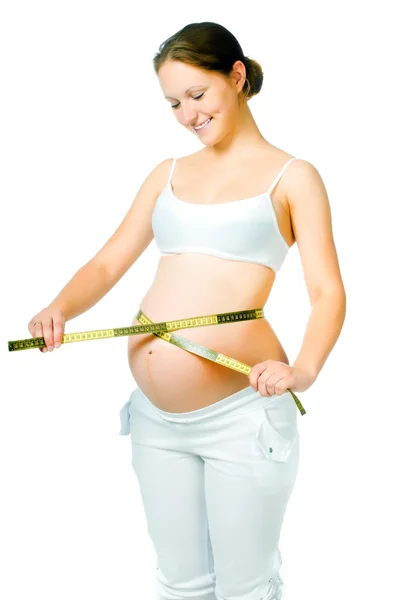 Pregnant woman measuring belly Stock Image