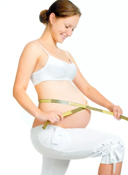 Беременная женщина, измеряющая живот Лицензионные Стоковые Изображения