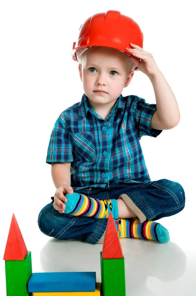 Little boy in a red construction helmet — Stock Photo, Image