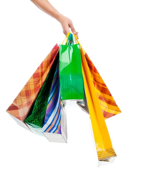 Mão feminina segurando sacos de compras — Fotografia de Stock