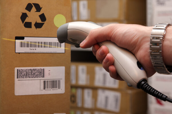 Man hand with barcode scanner in operation.