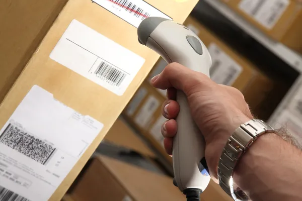Man with barcode reader works on warehouse — Stock Photo, Image