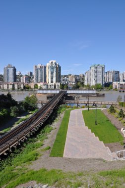 Modern apartment building with train merge place clipart