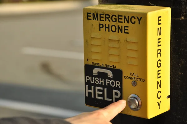Pushing emergency phone for help — Stock Photo, Image