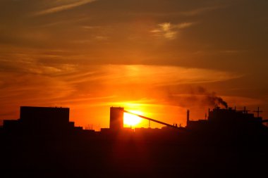 Sun setting behind Mosaic Potash Mine in Saskatchewan clipart