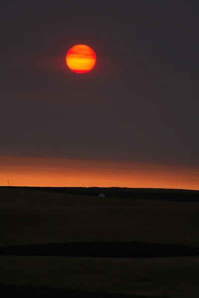 Rising sun behind thin clouds in scenic Saskatchewan — Stock Photo, Image
