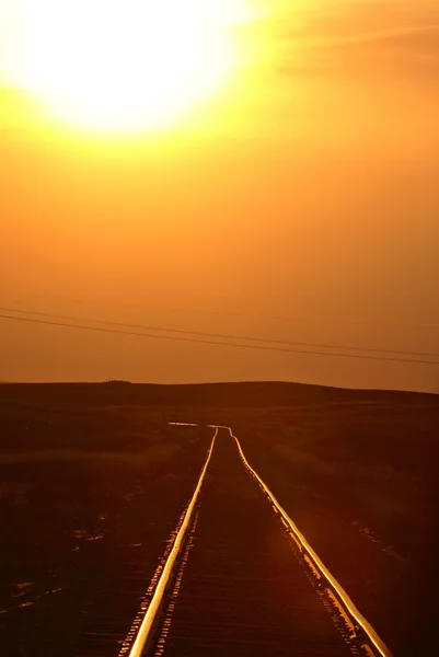 Setting sun lighting up Saskatchewan railroad tracks — Stock Photo, Image