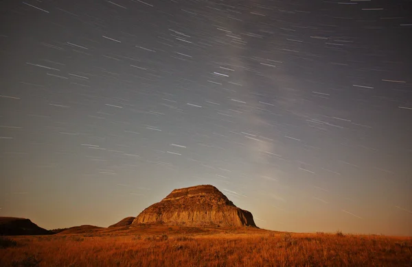 Stock image Moon lit Castle Butte and star tracks in scenic Saskatchewan