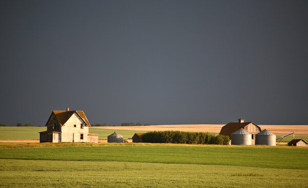 Storm clouds over some Saskatchewan farm buidlings