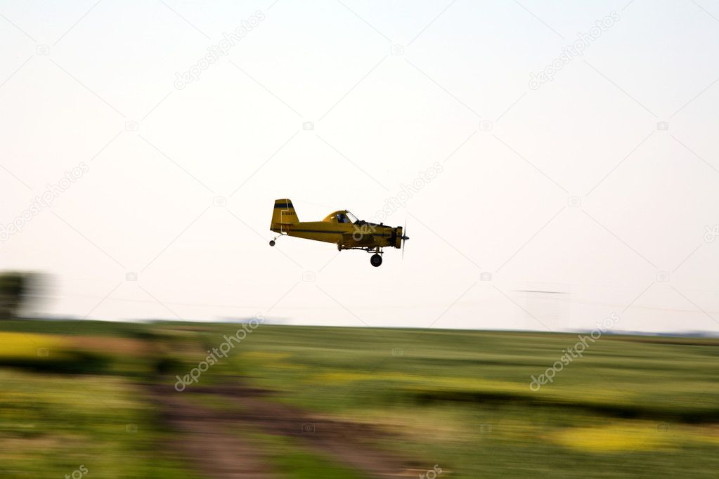 Cropduster airplane about to spray a Saskatchewan field