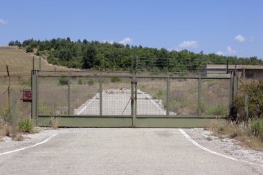 Locked gate leading to an abadonned terrain clipart