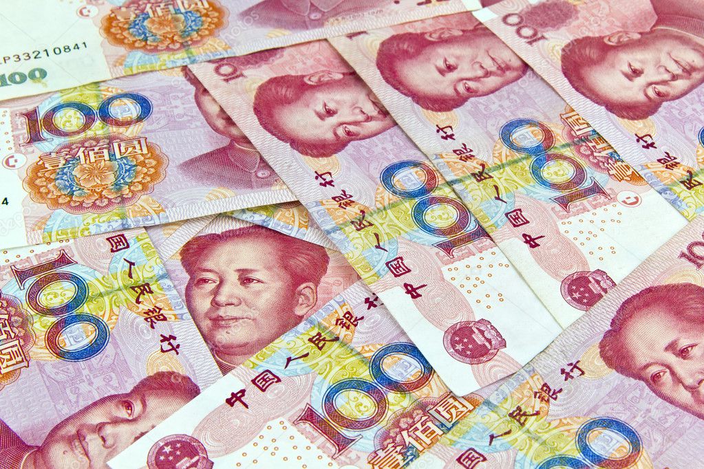 Chinese 100 Yuan bill face within pile of other 100 Yuan bills.