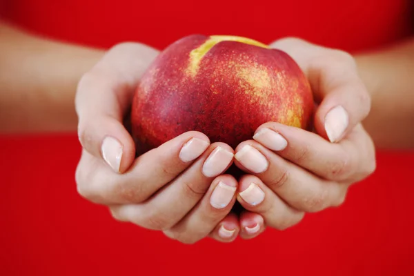 Peach in woman hands — Stock Photo, Image