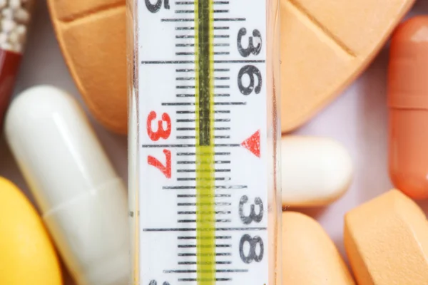 Thermometer and drugs Stock Picture