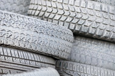 Close-up. the white automobile tires dumped in a a big pile clipart