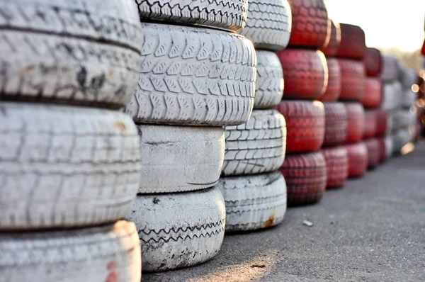 Racetrack fence of white and red of old tires — Stock Photo, Image