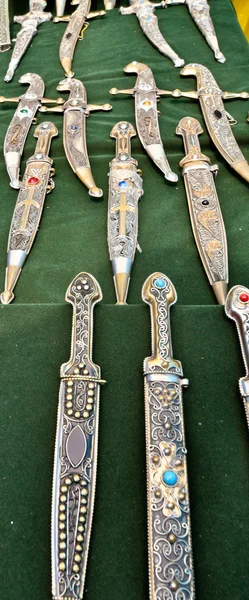 Original antique daggers on a green cloth — Stock Photo, Image