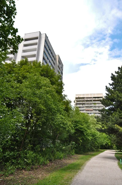 stock image Modern apartment house in the thickets of trees