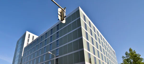 Edifício moderno e traficantes contra o céu azul — Fotografia de Stock