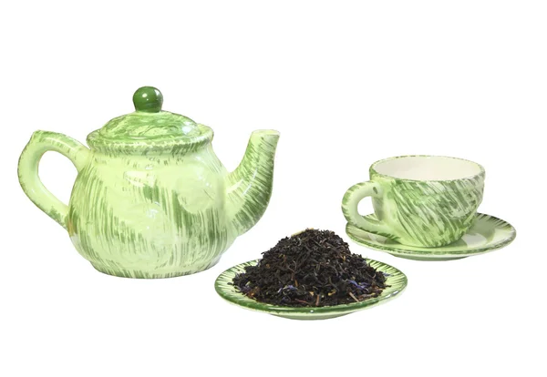 Ένα πράσινο τσαγιέρα, μια κούπα και το μαύρο τσάι σε ένα πιατάκι — Φωτογραφία Αρχείου