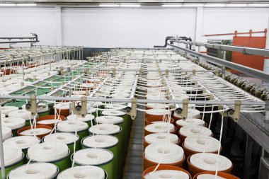 Cotton being processed for yarn manufacturing clipart