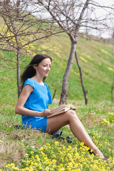 stock image Girl reading book in spring park