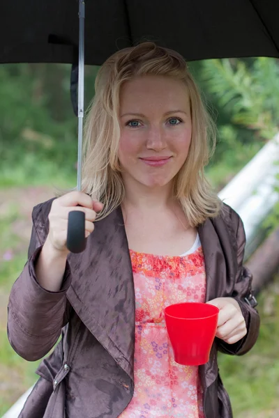 Portrait of a girl with an umbrella and tea — Stock Photo, Image