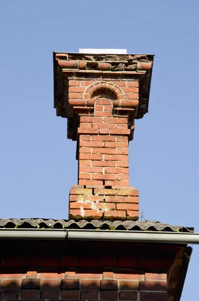 stock image Antique red brick chimney.