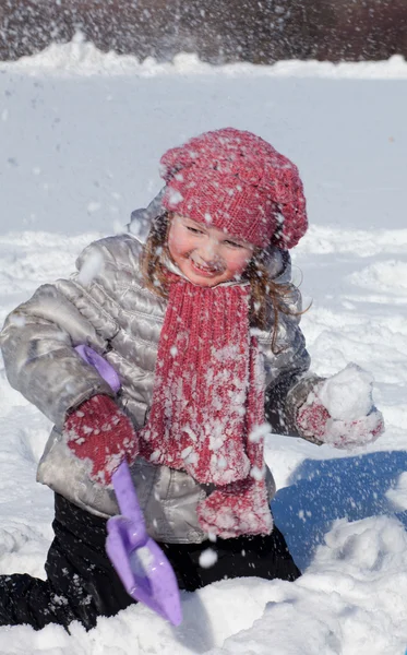 The girl plays on snow — Stock Photo, Image