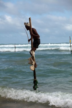 Traditional sri lankan stilt fisherman clipart